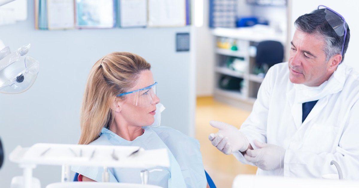 Dentist talking with his patient can braces cause gum recession