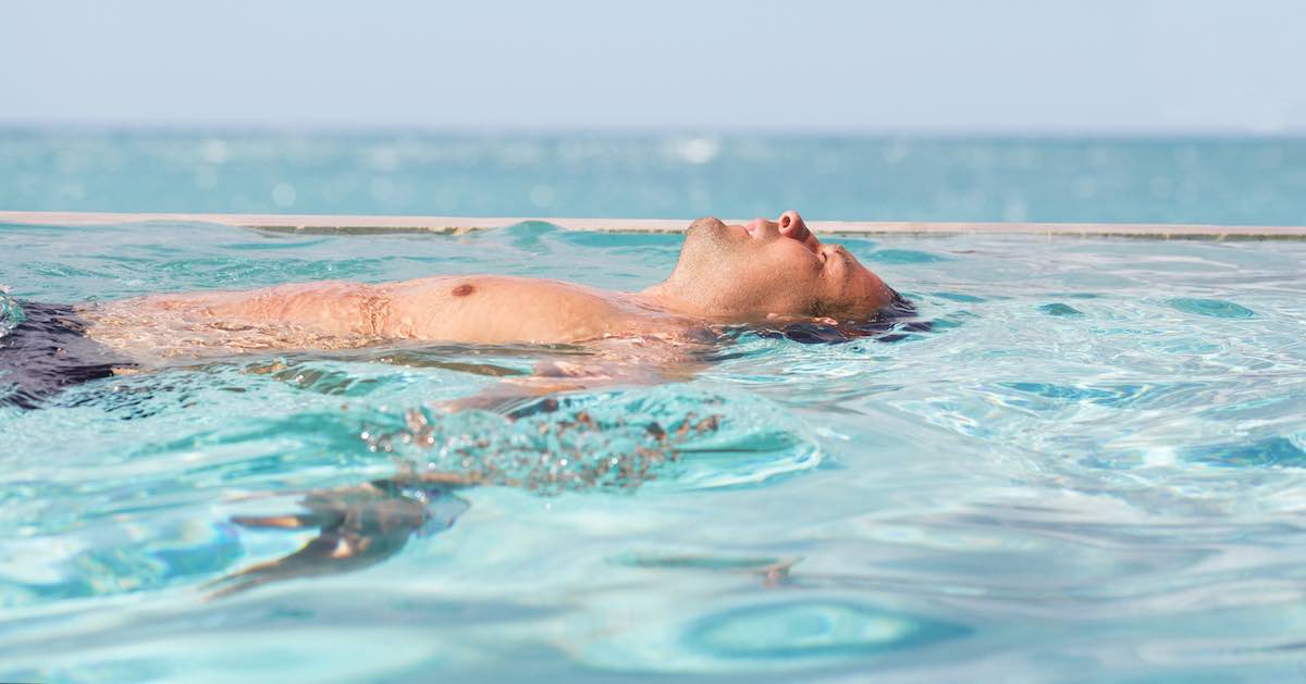 Man relaxing in the swimming pool relaxing man in pool
