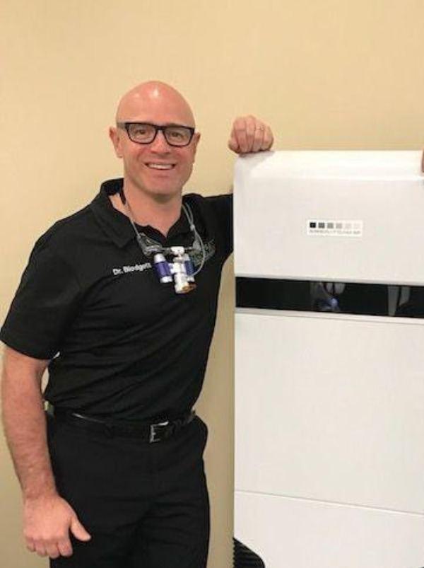 New Surgically Clean Air - 600 x 803 Dr. Kelly Blodgett & Dr. Bryan Neish stand proudly next to one of the many "Surgically Clean Air" units located in Blodgett Dental Care